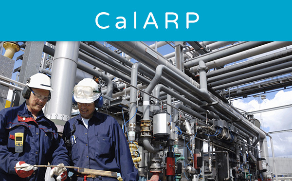 Two engineers inspecting equipment at an industrial plant.