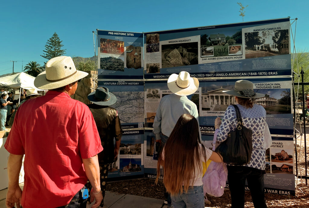 Visitors viewing a Ventura County history exhibit at a local outdoor event.