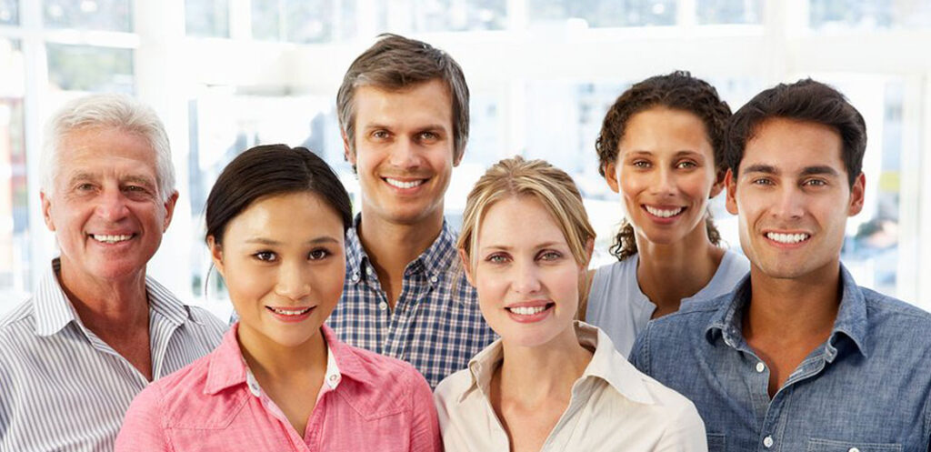 Group of six diverse smiling individuals portraying a sense of community.