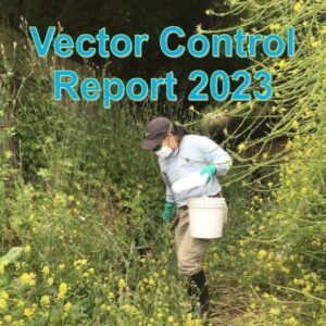 A person in protective gear holding a white bucket while working in a field of tall, weedy vegetation. Text overlay reads "Vector Control Report 2023".