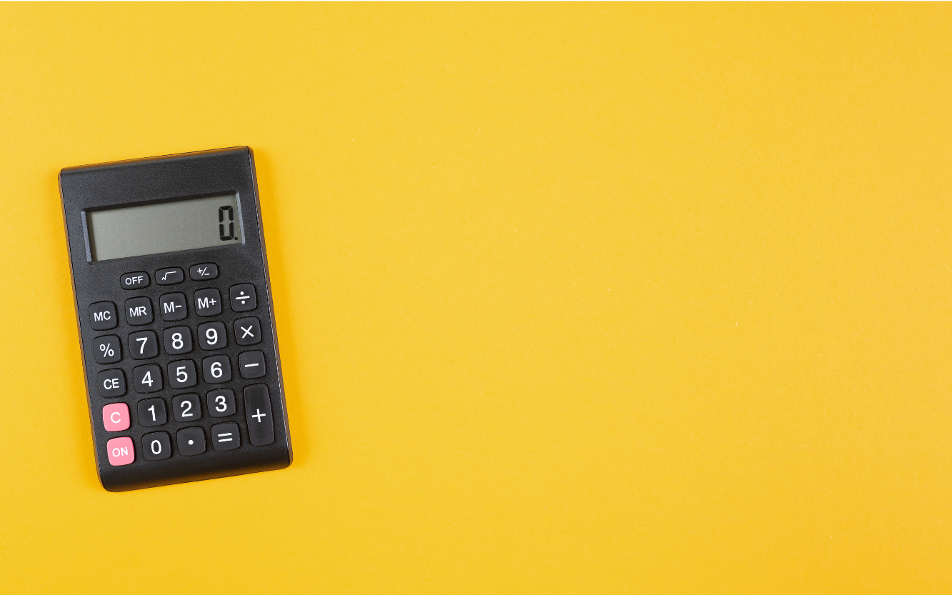 Black calculator on a yellow background.