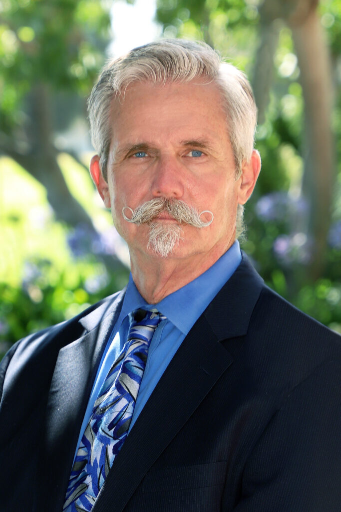 Portrait of a man with a mustache, in a suit and tie