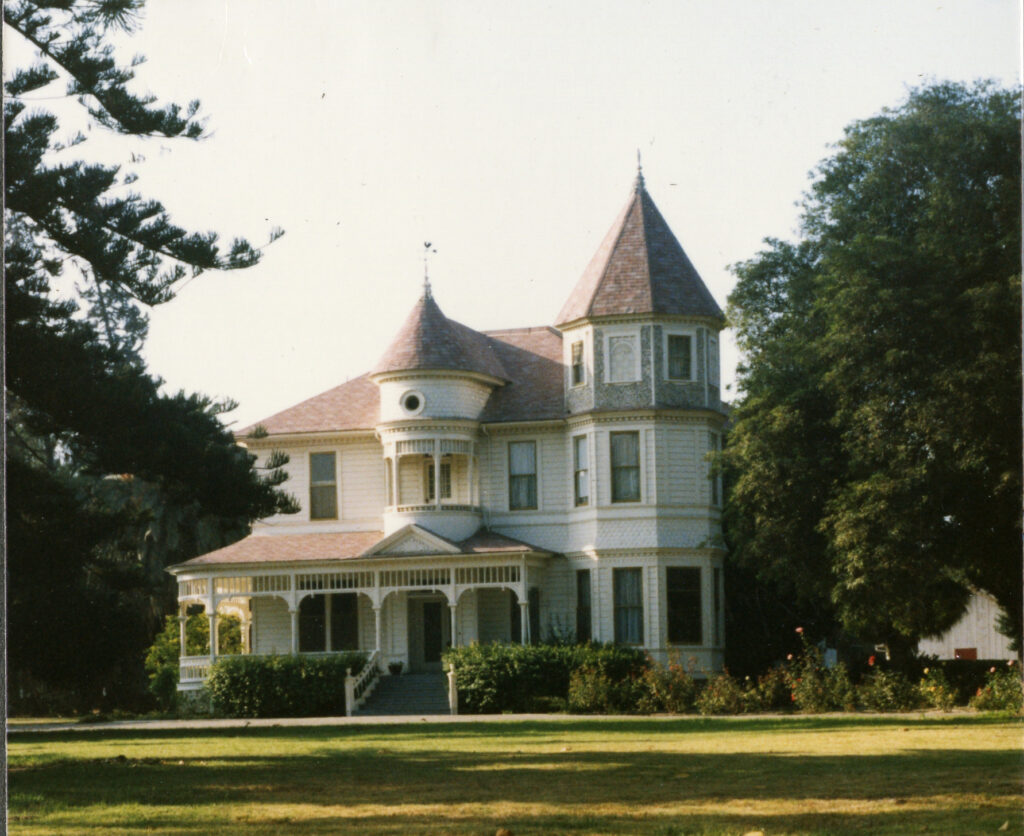 View of the Camarillo House, a Victorian-era residence with a turret and wraparound porch, circa 1980s.