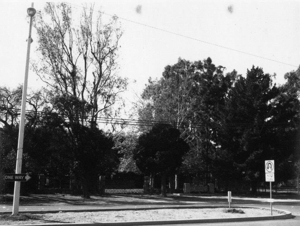 Black and white view of Thomas R. and Mary Bard Memorial with trees and road signs